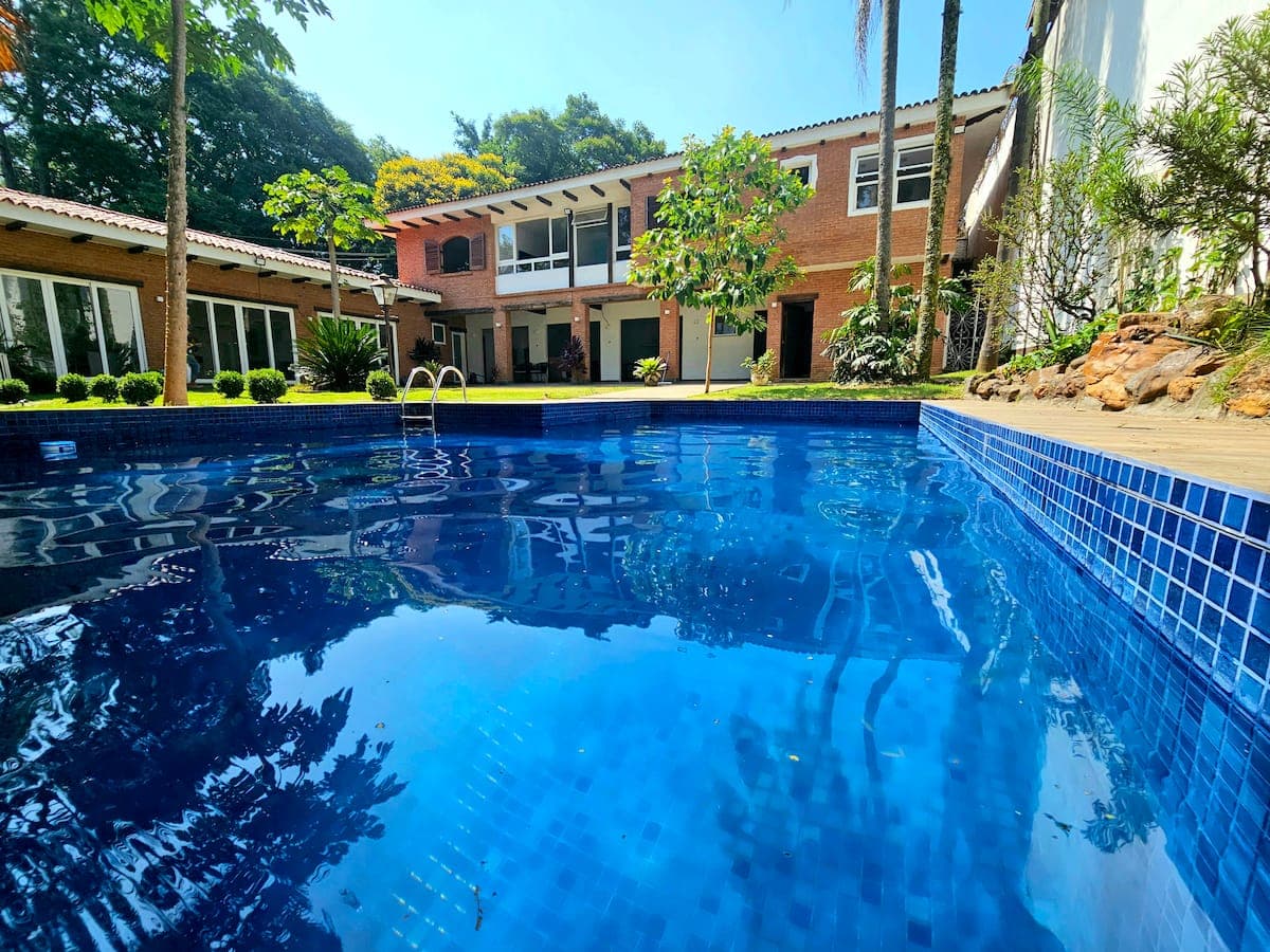 Piscina grande com a casa ao fundo